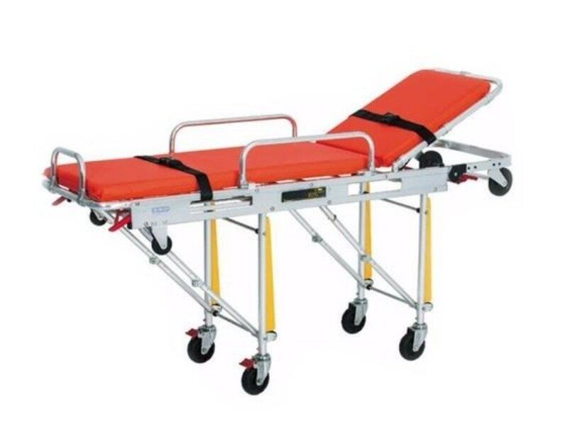Ambulance stretcher with high frame, patient straps, and red mattress